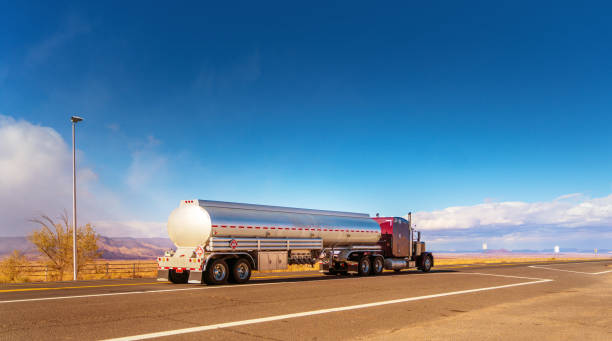 Fuel tanker driving on a single lane road USA Fuel tanker driving on a single lane road USA fuel truck photos stock pictures, royalty-free photos & images
