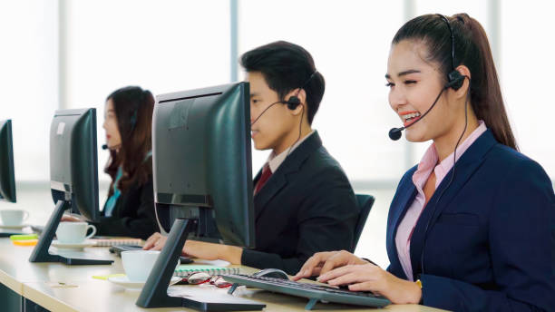 istock Business people wearing headset working in office 1297259186