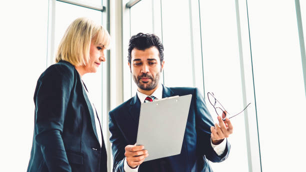 istock Two business people talk project strategy at office 1297260149