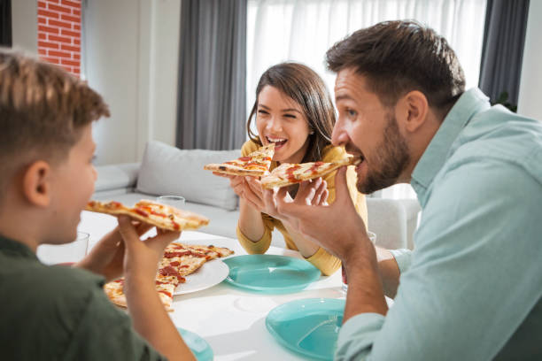 istock Family eating pizza 1297260623