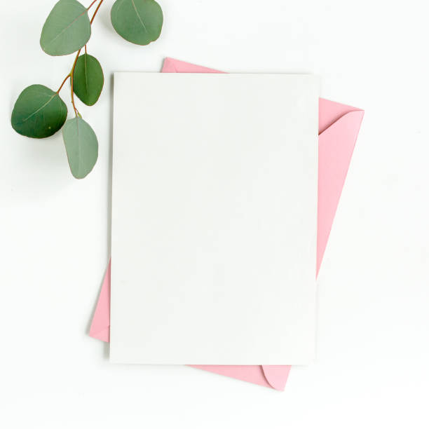 istock Mockup invitation, blank greeting card and green leaves eucalyptus. Flat lay, top view 1297261812