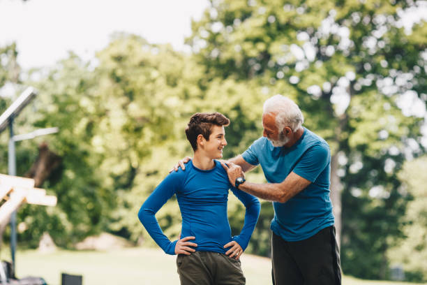 istock Grandfather is supporting his grandson to continue working out. 1297262125