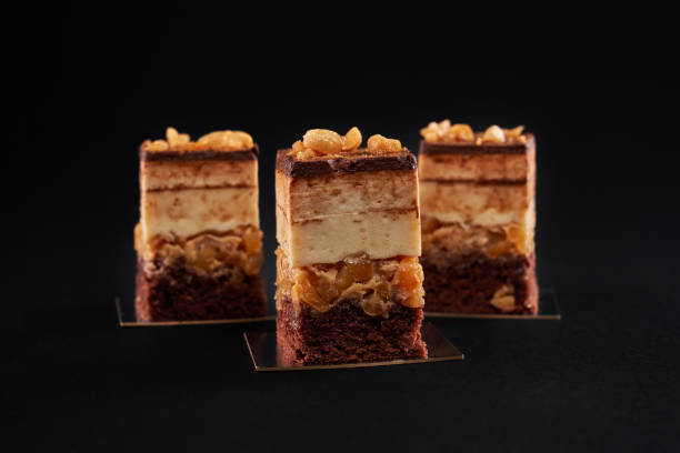istock Chocolate biscuit mousse cake pieces isolated on black. 1297262296