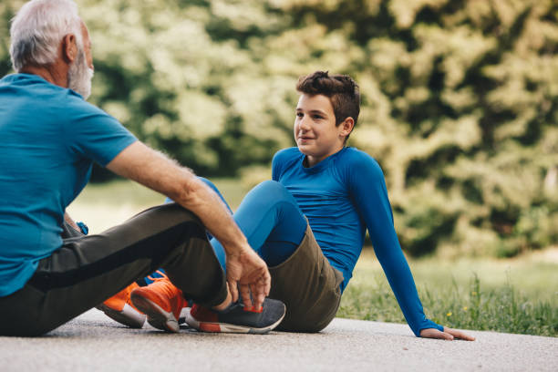 istock Active senior with his grandson sitting and resting after exercising. 1297262495