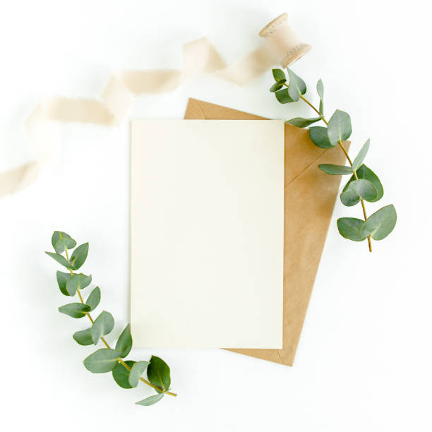 istock Mockup invitation, blank greeting card and green leaves eucalyptus. Flat lay, top view 1297263210