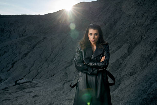 istock Female model wearing leather coat posing in quarry. 1297263428