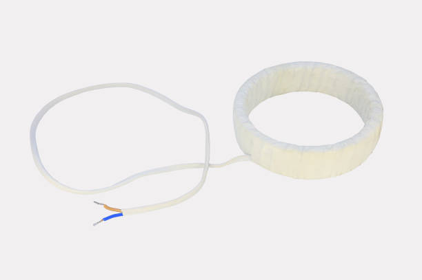 istock Electric toroidal measuring transformer with a wire is isolated on a gray background 1297264736
