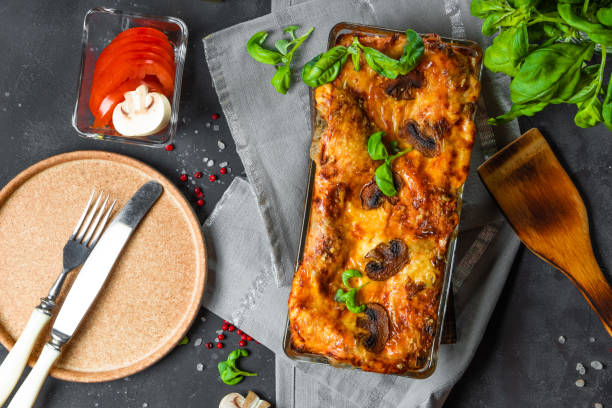 istock Vegetarian lasagna with mushrooms, tomatoes and basil, top view 1297264818