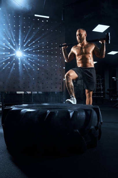 istock Muscular man holding sledgehammer behind neck. 1297264889