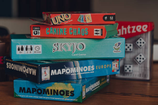 stack of modern and classing board games on a table. - editorial horizontal close up uk imagens e fotografias de stock