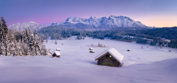 Beautiful panorama of pink hues of winter landscape in the mountains