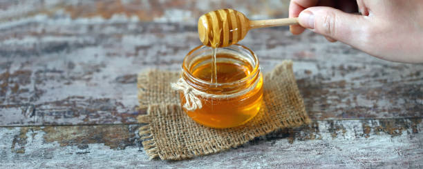 istock Jar of honey. Stick for honey. 1297266953