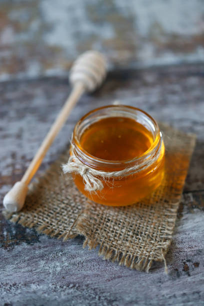 istock Jar of honey. Stick for honey. 1297266970