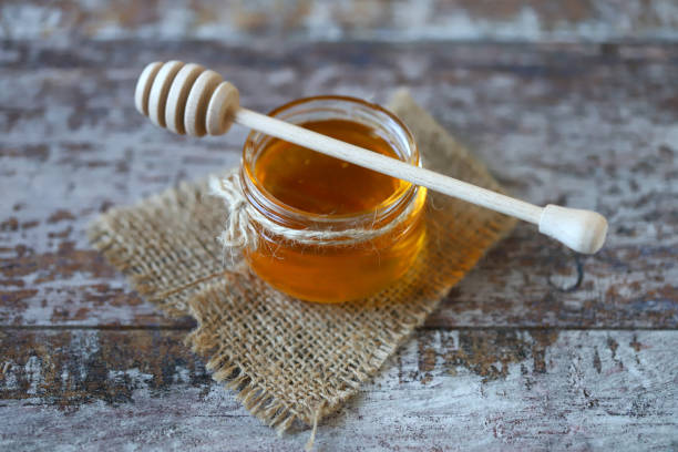 istock Jar of honey. Stick for honey. 1297266988