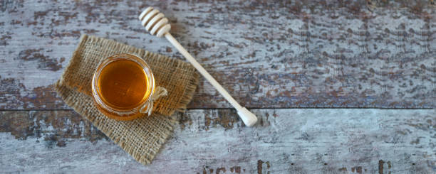 istock Jar of honey. Stick for honey. 1297266994