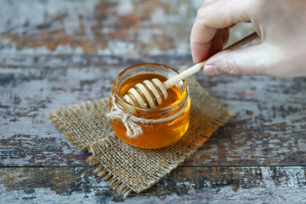 istock Jar of honey. Stick for honey. 1297267005