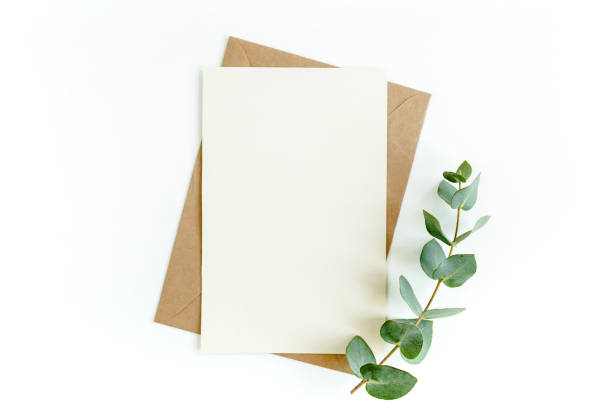 istock Mockup invitation, blank greeting card and green leaves eucalyptus. Flat lay, top view 1297267212