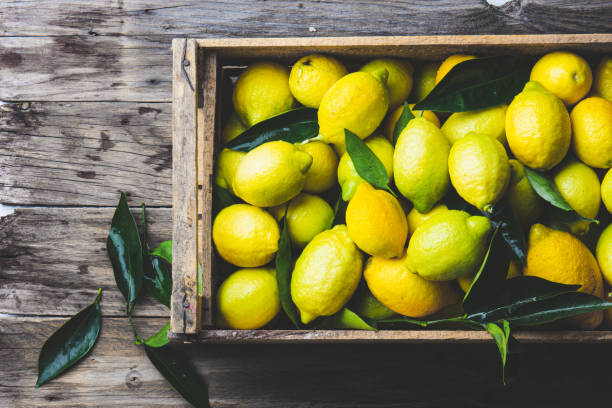 istock Full box of fresh lemons. Top view, copy space 1297268676