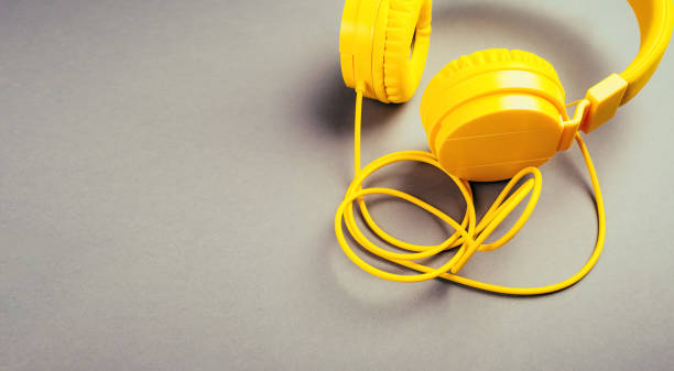 istock Yellow headphones on a gray background 1297269000