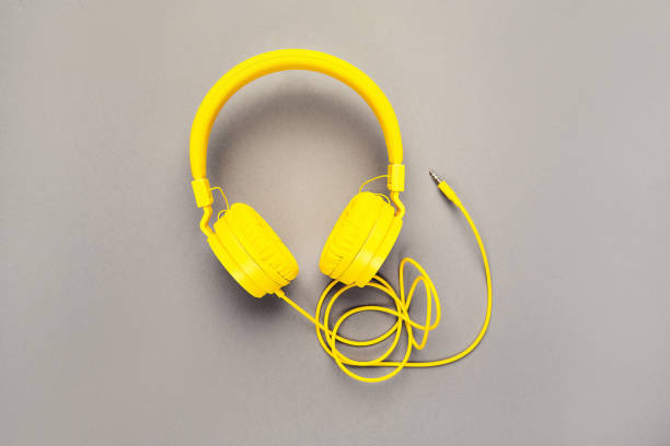 istock Yellow headphones on a gray background 1297269015