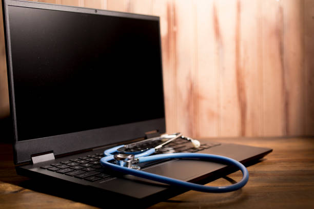 istock Stethoscope on keyboard of open laptop. 1297269849