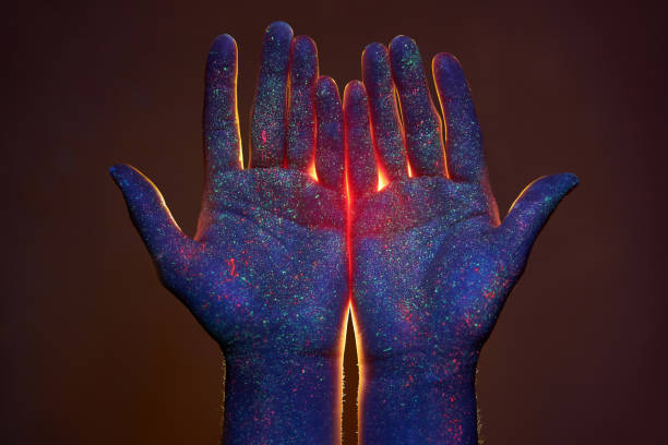 istock Light through the palms of your hands in ultraviolet, God and religion. Divine light through hand fingers, prophet Muhammad 1297270597