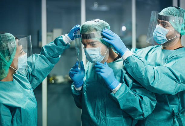 istock Doctors wearing ppe equipment face surgical mask and visor fighting against corona virus outbreak - Health care and medical workers concept 1297272774