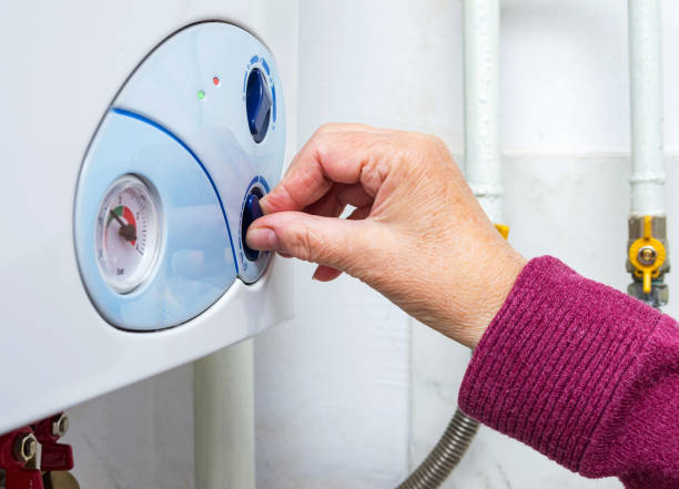 istock Elderly woman adjusting her heating boiler for warming apartment 1297272965