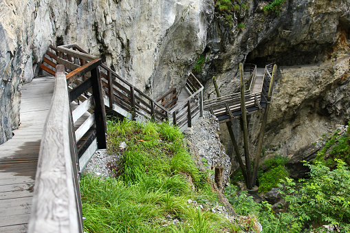 A wooden path through the gorge in the Alps.