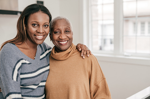 Two smiling people - senior women and her adult daughter