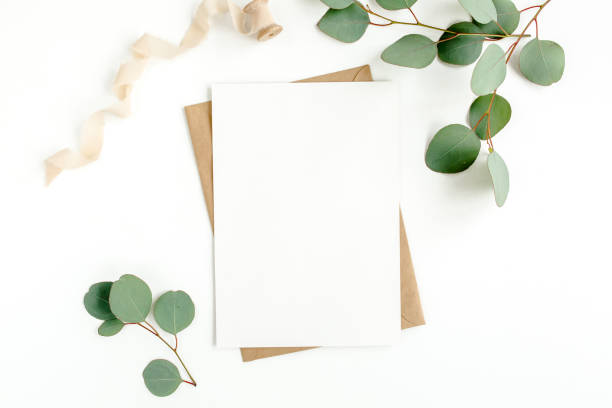 istock Mockup invitation, blank greeting card and green leaves eucalyptus. Flat lay, top view 1297274443