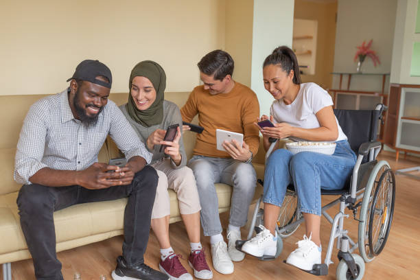 istock Happy Group of Young Multicultural Friends are Hanging Out at Home While Using Their Digital Devices. 1297274716