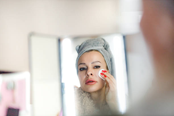 istock Reflection in a mirror of a woman removing her make up 1297275625