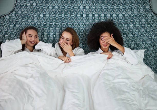 istock Three ladies enjoying time in bedroom together 1297275798