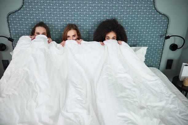 istock Three best girlfriends enjoying bedtime and looking at camera 1297275808