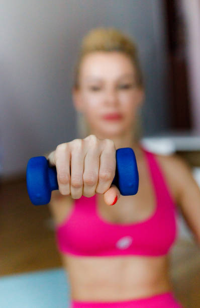 istock Close up of woman exercising with dumbbell 1297275940