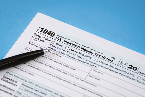 Close Up of Tax Form 1040 on Light Blue Background