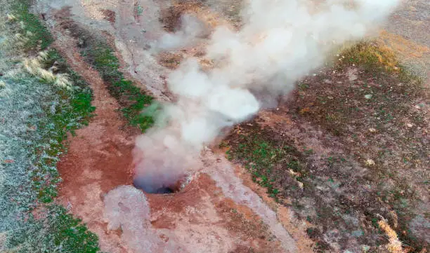 Photo of Drone view looking down onto geothermal steam vent in the Nevada Desert.