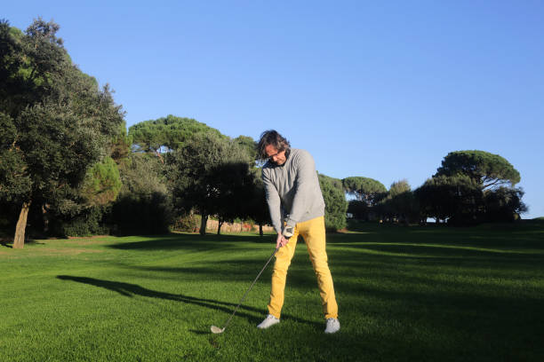 istock adult man in a golf iron swing 1297277662