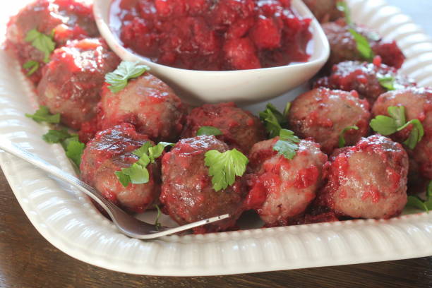 istock Hot meatballs with cranberry sauce on white plate 1297277758