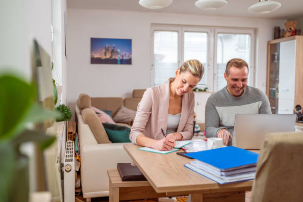istock Young adult couple working from home 1297280168
