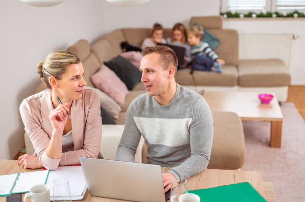 istock Young adult couple working from home 1297280198