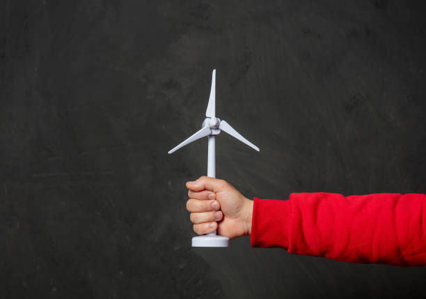 istock male hand hold little wind generatior on dark background 1297280495