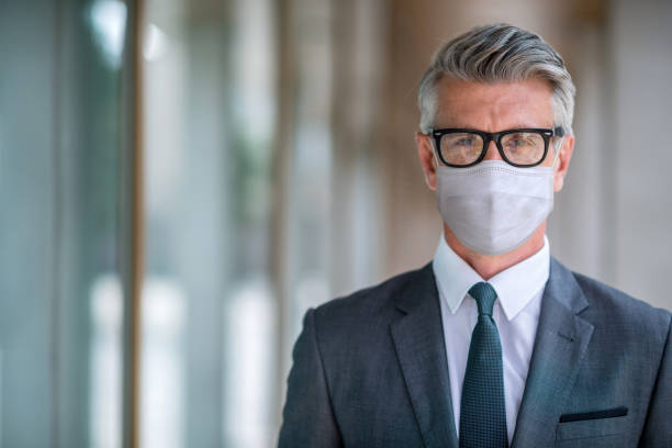 istock Successful business man wearing a facemask during the pandemic 1297281093
