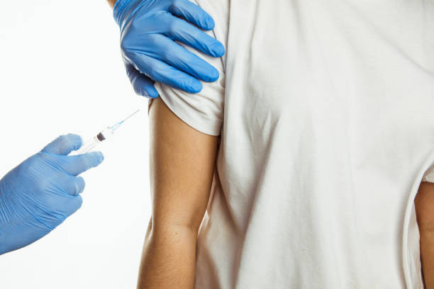 istock making injection of vaccine in shoulder white background 1297281229