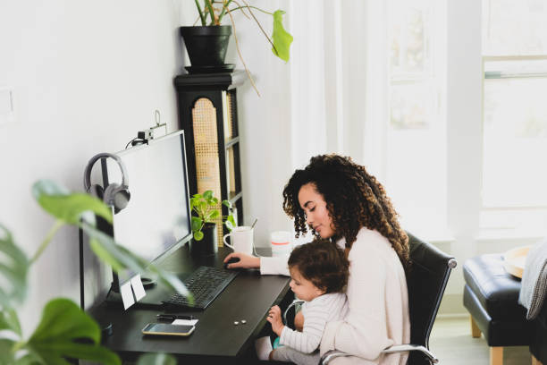 istock Mom waits for baby to finish snack before continuing work 1297281352