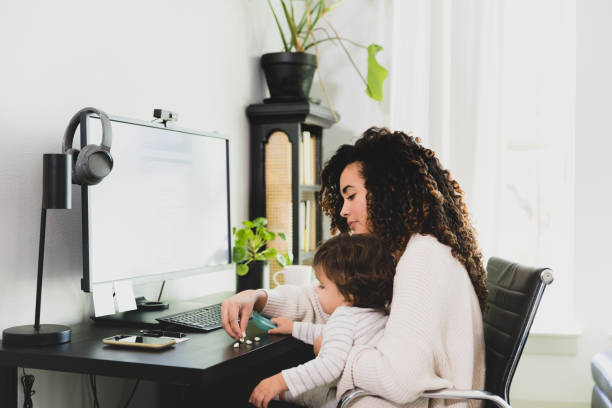 istock Mid adult mom takes break from work to feed son 1297281359