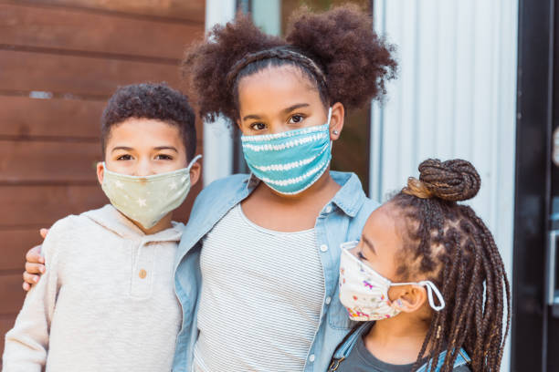 istock Loving siblings wearing face masks during pandemic 1297281566