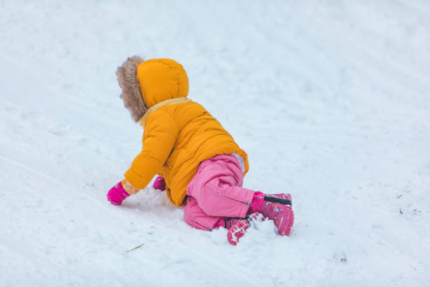 istock little girl playing outdoors in snow 1297281677