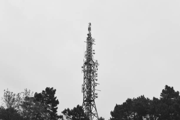 istock With smart cellular antennas radiating and broadcasting strong digital signal waves from the top. Mobile telephone network base station telecommunication tower. big tower 1297281719